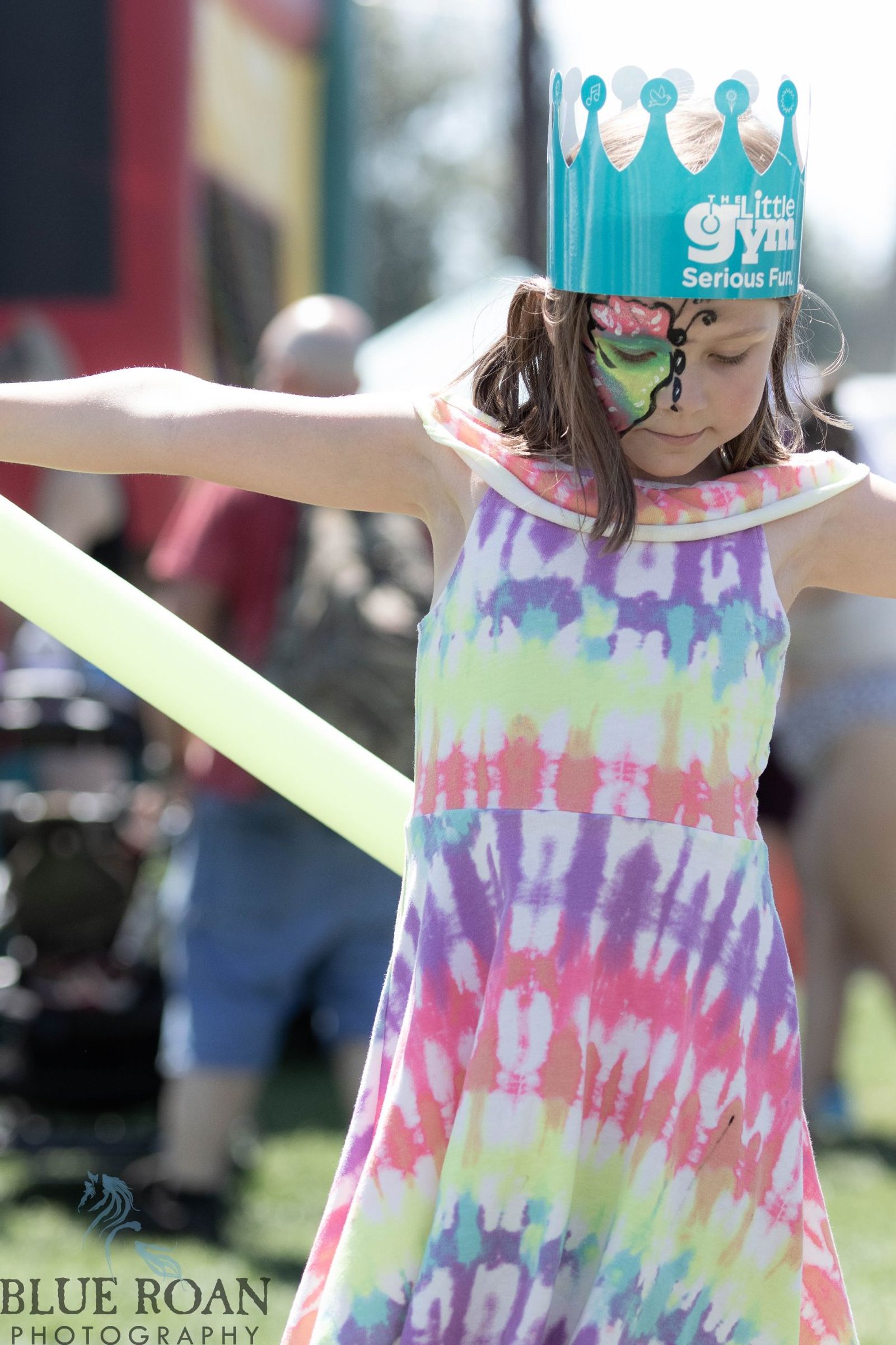 Child with painted butterfly face at Family Fun Fest